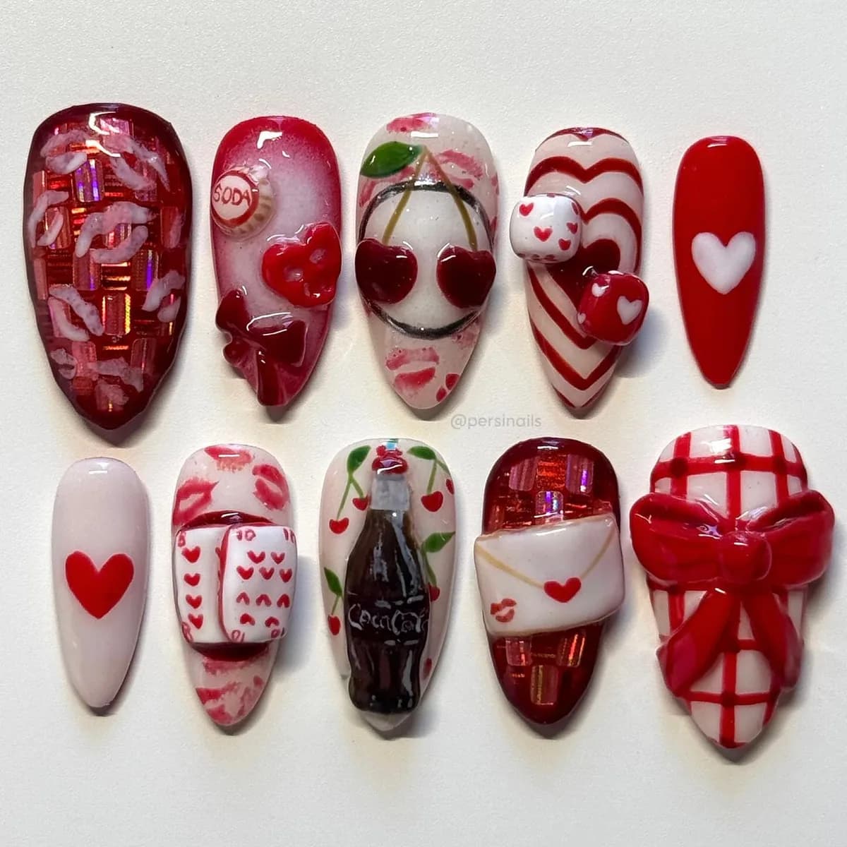 Ten press-on nails in jelly crimson and white, with sculpted hearts, a soda bottle, a love letter and a gingham bow.